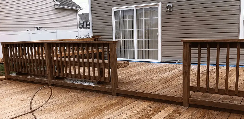Deck sealing service protecting a backyard wood deck and railings in Toledo, OH
