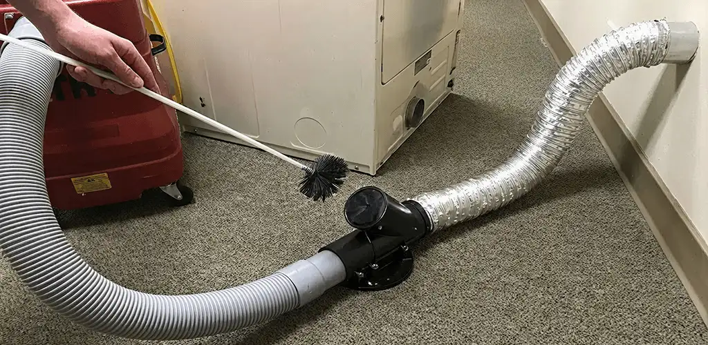 Dryer vent cleaning service removing lint from a dryer duct connection in Toledo, OH