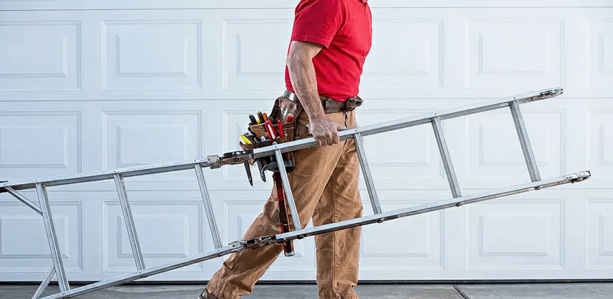 Garage door repair technician arriving with tools and ladder in Toledo, OH