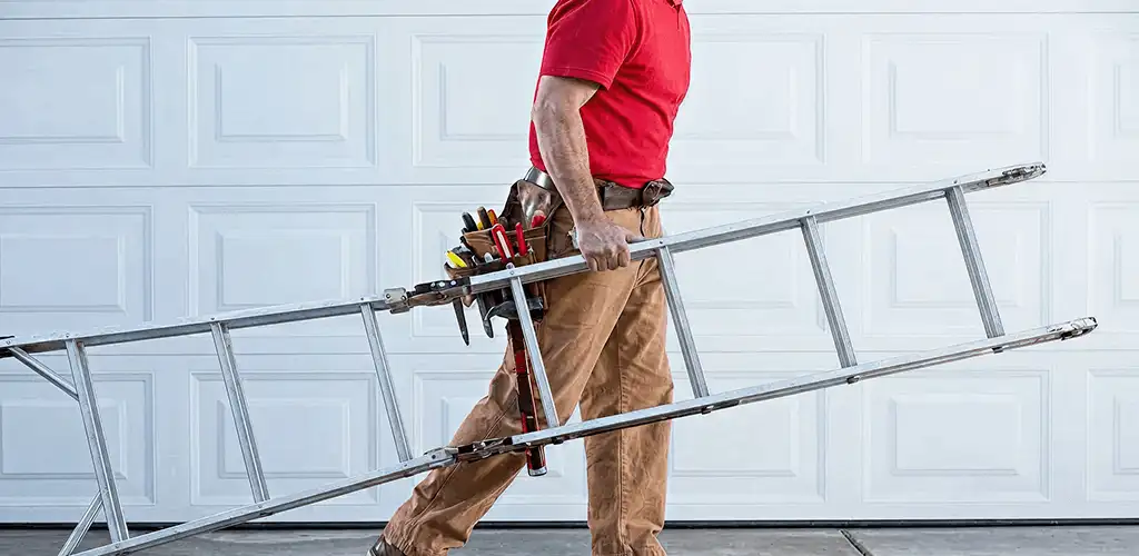 Garage door repair technician arriving with tools and ladder in Toledo, OH