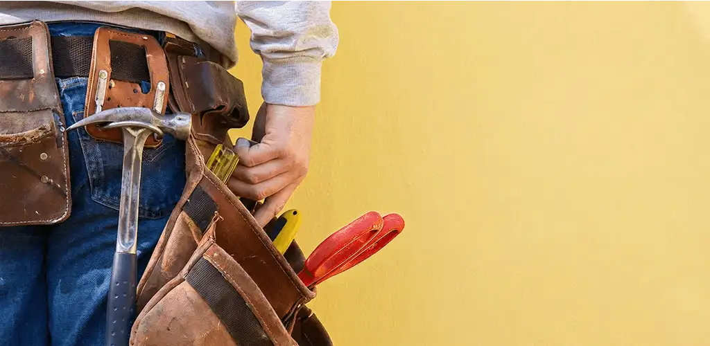 Handyman with tool belt ready for home repairs and maintenance in Toledo, OH