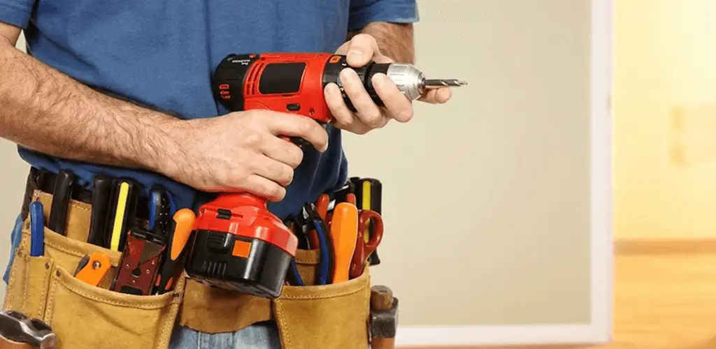 Handyman holding a power drill for home repairs and installations in Toledo, OH