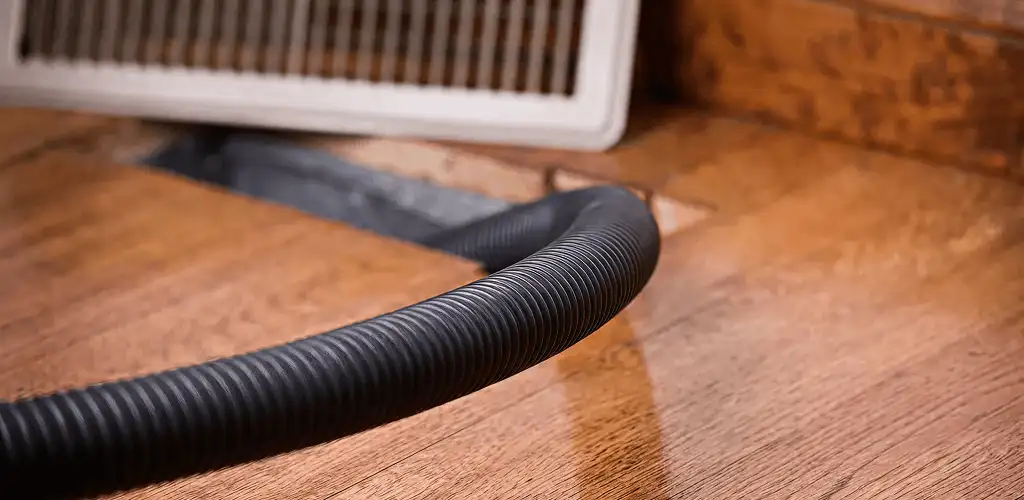 Air duct cleaning hose inserted into a floor vent for ductwork cleaning in Toledo, OH