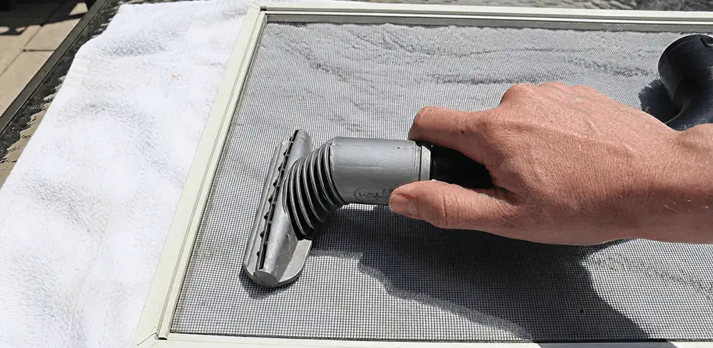 Window screen repair cleaning and fixing a damaged screen mesh in Toledo, OH